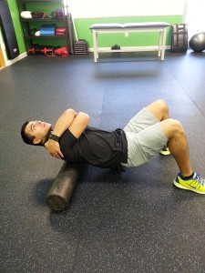 Personal Trainer Jonathan Avalos foam rolling at Shape Up Fitness & Wellness Consulting